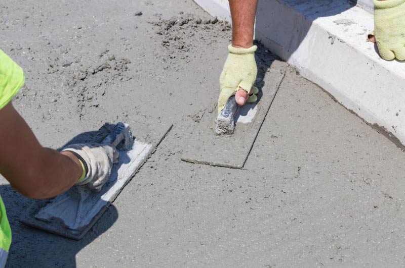 GVG Concrete crew hand-troweling and edging a fresh concrete slab